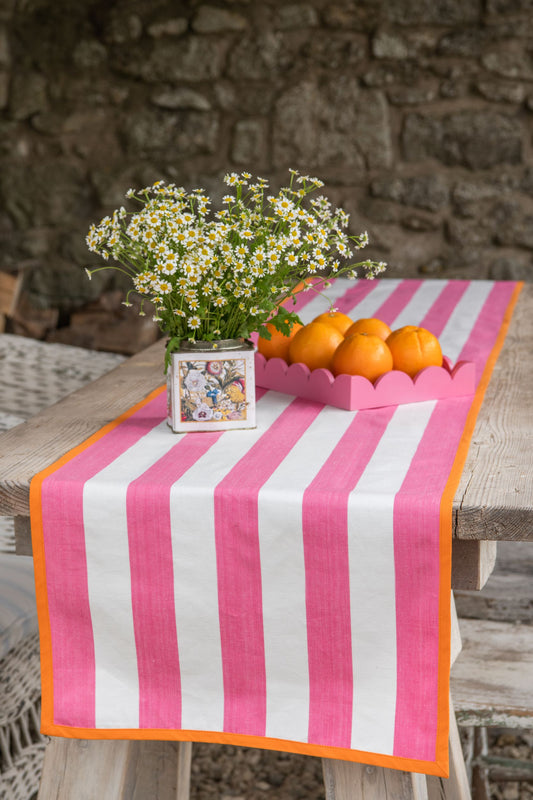 pink striped table runner with orange edging