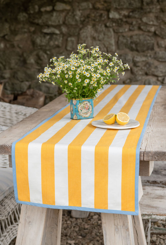 yellow striped table runner with blue edging