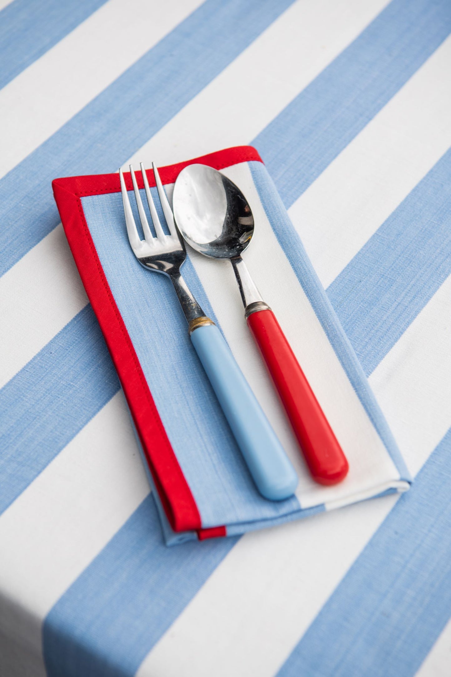 blue striped napkin with red edging
