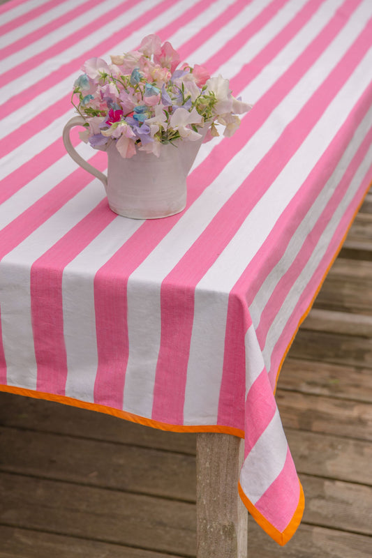 pink striped tablecloth with orange edging