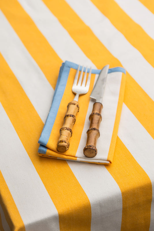 yellow striped napkin with blue edging